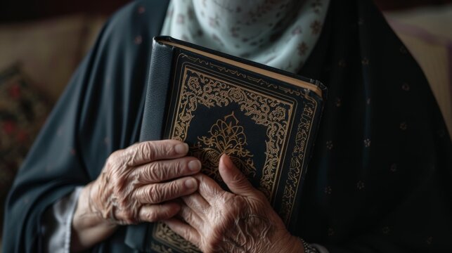 person holding quran with background is blurred but gives off a warm and calm ambiance
