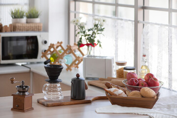 Equipment for making drip coffee is prepared and placed on the kitchen table at home, kitchen background
