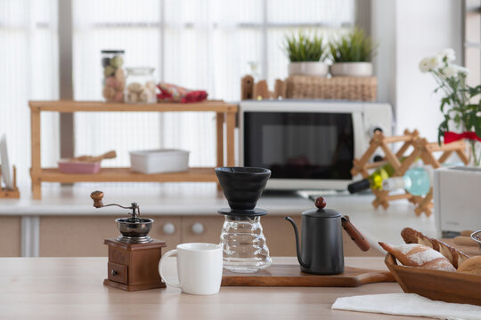 Equipment for making drip coffee is prepared and placed on the kitchen table at home, kitchen background