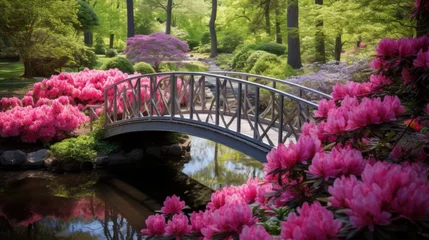 Zelfklevend Fotobehang A garden bridge framed by colorful azaleas © Cloudyew
