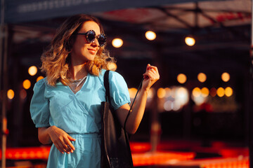 Beautiful Woman with Oversized Sunglasses and Shopping bag. Cheerful girl on a shopping spree...