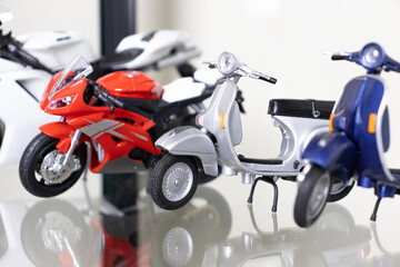 Selective focus. Model of motorbikes placed on glass shelf. After some edits.