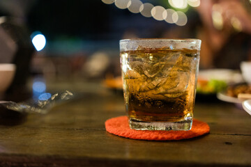 Glasses of ice whiskey on wood table. At the end of a hard day