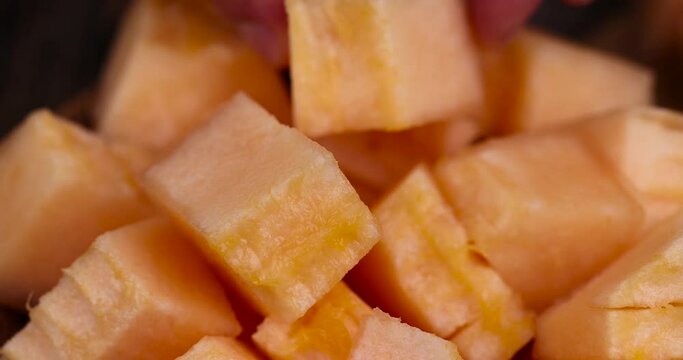 sliced orange melon close-up, delicious soft and ripe food melon on the table
