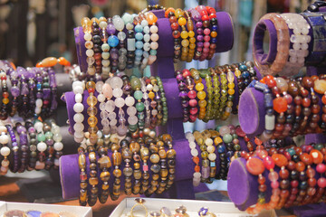  Bracelets with beads, laid out in the street market in the sun.