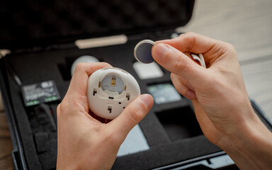 A technician works with a demo kit of the smart home system