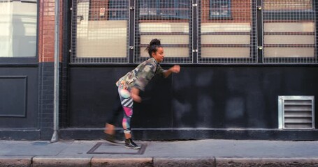 Woman in city, dance with energy and hip hop outdoor, happy with music and creativity for fun. Rhythm, motion and moving on sidewalk, urban and dancer in streetwear with freedom and performance