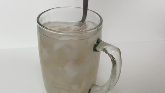 Beverage made from chilled or iced coconut water and young coconut flesh, isolated on white background