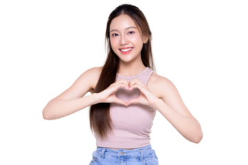Attractive Asian woman feels happy and makes a romantic hand sign heart shape isolated on a transparent background, PNG file format. People affection and care concept.