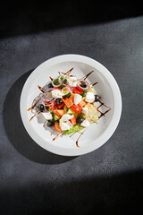 Overhead view of a traditional Greek salad with feta cheese and balsamic drizzle, a Mediterranean delight