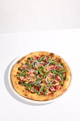 Gourmet tuna and olive pizza in nicoise style on a white background