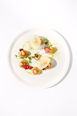 Top View of Seared Sea Scallops with Apple and Celery Puree on White