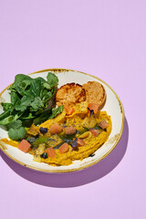 Healthy eating concept with sweet potato pate, mixed greens, and peanut bread on pastel backdrop. Ideal for nutritious diet and meal planning