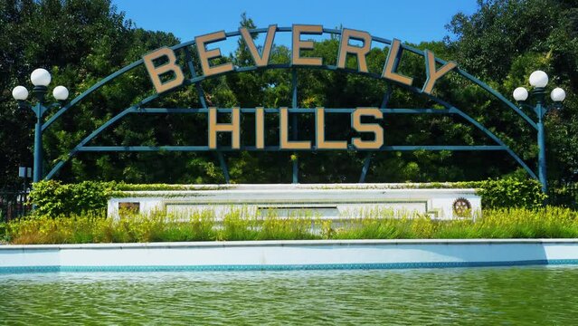 Beverly Hills, California, United States &ndash; April 16, 2019: Beverly Hills main city sign. Beverly Hills landmark and lake with sunlight reflection. City name at Beverly Gardens Park.