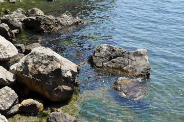 Seascape. Waves wash over a large stone by the sea
