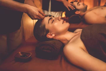 Foto op Canvas Caucasian couple enjoying relaxing anti-stress head massage with hot stone and pampering facial beauty skin recreation leisure in warm candle light ambient salon spa in resort or hotel. Quiescent © Summit Art Creations
