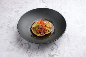 Smoked Salmon Tostada with red caviar and avocado