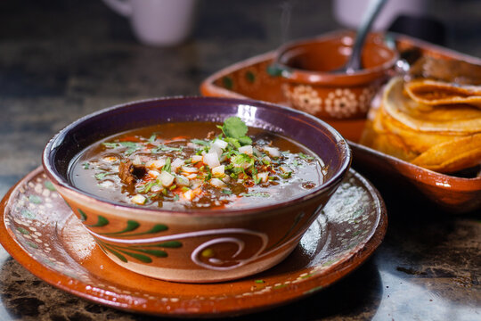 Traditional Mexican dish with beef birria with red sauce. Mexican food