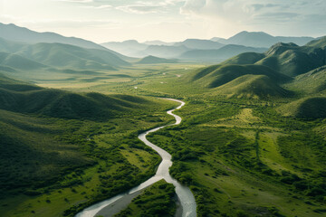 Meandering River Through Lush Green Valleys, An aerial view captures a meandering river cutting through vibrant green valleys, with rolling hills fading into the misty horizon.