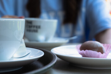 A table of cakes and coffee at a girl's breakfast.