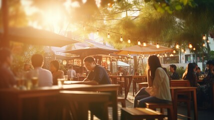 Fototapeta na wymiar People enjoying music and beer at an outdoor street bar in Asia, bokeh effect