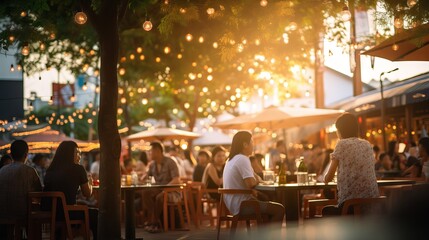 People enjoying music and beer at an outdoor street bar in Asia, bokeh effect