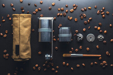 Disassembled manual coffee grinder on a black background
