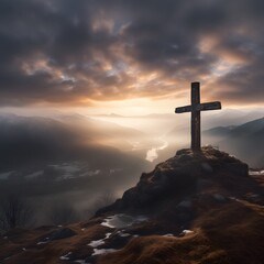 cross in the mountains during a misty winter sunrise