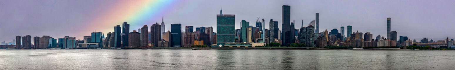 Fototapeta na wymiar Great panoramic view of the Big Apple skyline with a rainbow from Long Island which is an island that extends across New York (USA) and one of the best viewpoints in Manhattan.