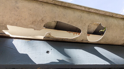 Damaged Gutters after a hail storm with holes and impact of large hailstones waiting gutter Repair...