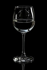 a glass of wine is shown on a black background