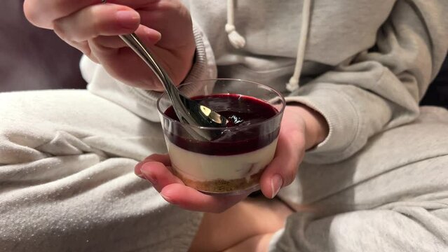 Yogurt with berry jam in spoon, curd cream swirl with fruit topping, blueberry whipped cream, ProRes uncompressed video. High quality 4k footage
