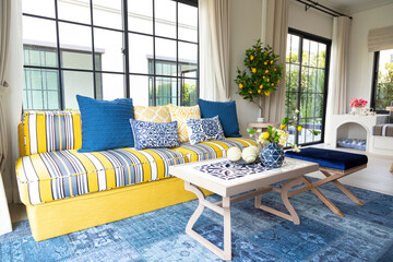 Mediterranean living room interior with bright yellow and blue sofa and pillow. Modern decor living...