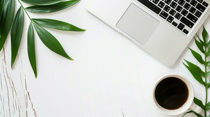 White empty background with a laptop and coffee in the right part of the image and a green leaf in the left part with space for text, inscriptions or graphics.