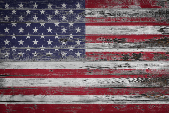 The national flag of  USA  is painted on uneven wooden  boards. Country symbol.