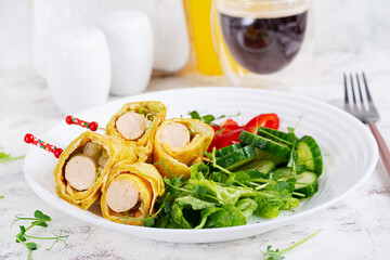 Ketogenic breakfast. Omelette with sausage. Sausage roll in omelette with lavash. Keto, ketogenic lunch. 