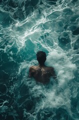 A man swimming in water waves