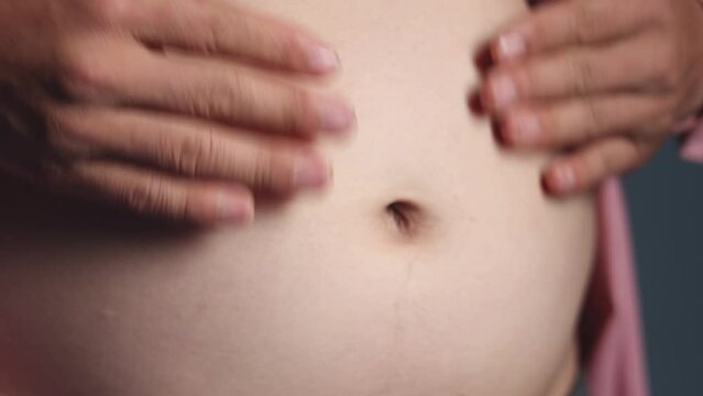 Closeup footage of overweight man touch and massage his stomach, body fat and healthcare concept, 4K 25fps hight resolution video