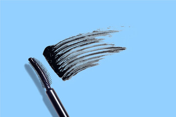 swatch, mascara brushstroke smear, mascara brush composition cosmetic on blue background