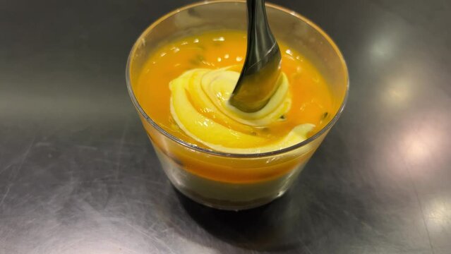 Dessert. Mango Panna cotta with passion fruit, kumquat and mint, Italian dessert, homemade rotation on dark black background. High quality 4k footage yogrut passion fruit