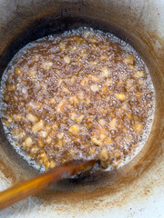 cooking traditional lard cracklings in big pot - 732983680