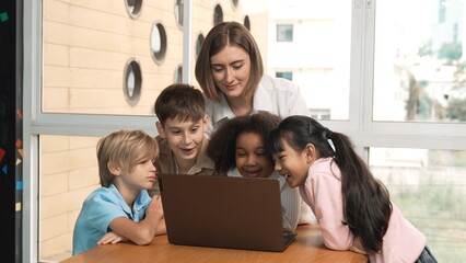 Cute african girl programing system while surround with caucasian teacher and diverse friend....