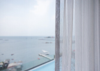 white transparent curtain with sea view background.
