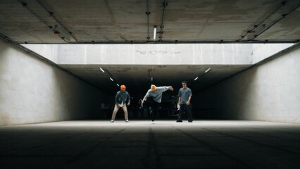 Panorama shot of hipster group dance together while perform b-boy dance. Street dancer team moving...