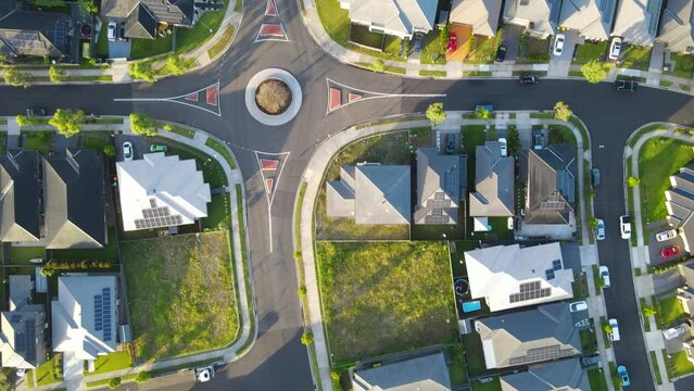 Aerial drone top down view above Jordan Springs East, known as the sinking suburb, in western Sydney, NSW Australia tilting upward to show the suburb on a sunny morning in February 2024