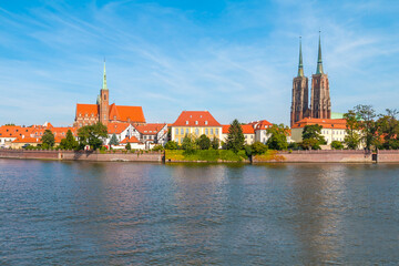 A view of Ostrów Tumski in Wrocław on a sunny day. In the background, you can see the Cathedral of St. John the Baptist.