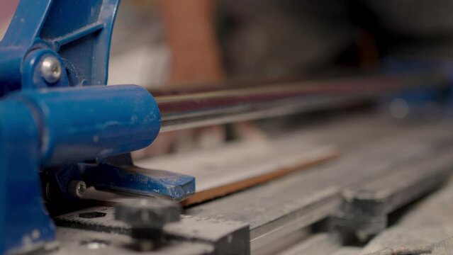 Close-up of a work tool using slice to cutting ceramic tiles. Installing, Renovation, Repairing home.