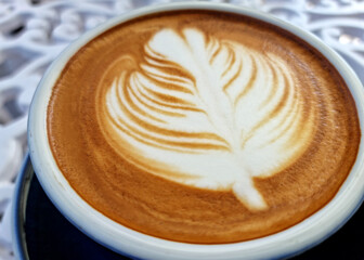 Sideway shop coffee, close-up hot latte art coffee background.