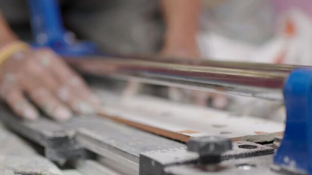 Close-up of a work tool using slice to cutting ceramic tiles. Installing, Renovation, Repairing home.