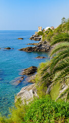 Genoa, Italy. View from the Anita Garibaldi promenade, of the sea and the coast of Nervi, on a sunny October day. In the distance the Gropallo Tower. Vertical image. 2023-10-06.
